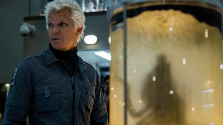 Timothy Olyphant's Kirsh stands next to an alien specimen container in Alien: Earth