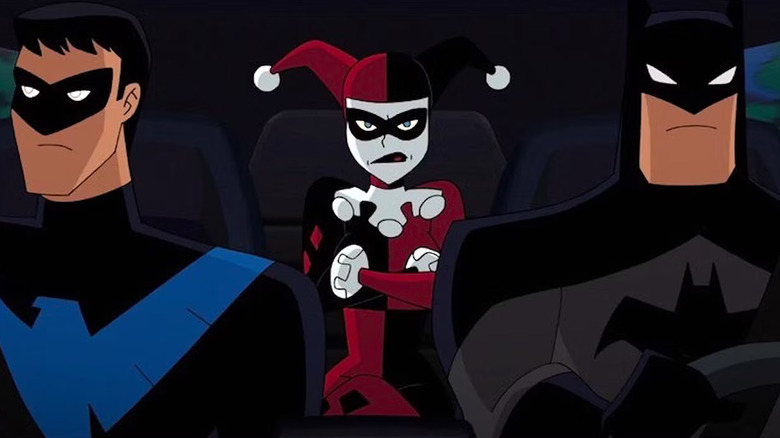 Nightwing and Batman sit in the front seat of a car with Harley Quinn in the back in Batman: The Animated Series.