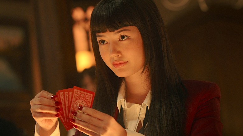 Yumeko holding several cards in her hands in Bet