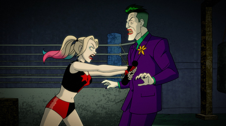 Harley Quinn pushes the Joker with a bat on the TV show Harley Quinn