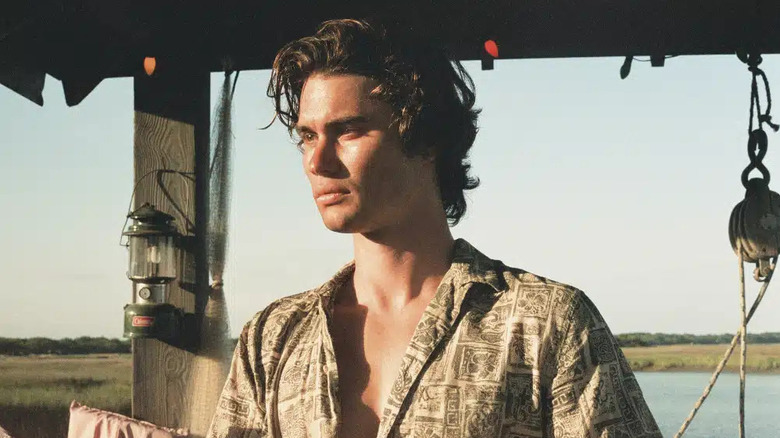 Chase Stokes looking moody and broody as John B in Netflix drama, Outer Banks.