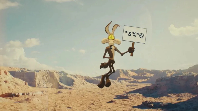 Coyote vs. Acme - Wile E. Coyote hovering mid-air, holding censored sign