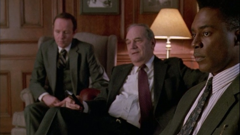 Adam Schiff is flanked by his subordinates.