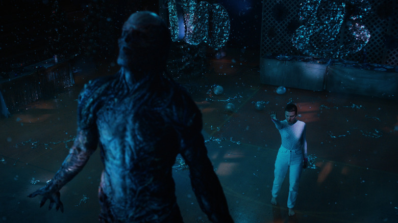 Jamie Campbell Bower as Vecna being lifted up by Millie Bobby Brown as Eleven in Stranger Things