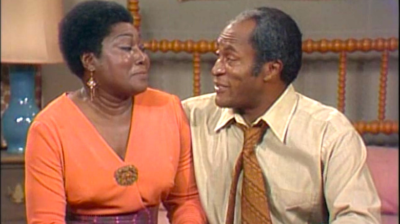 Esther Rolle as Florida Evans and John Amos as James Evans talk in Good Times.