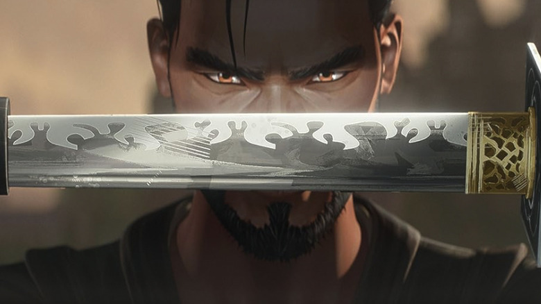 A man holds a sword and looks at the camera in Predator: Killer of Killers