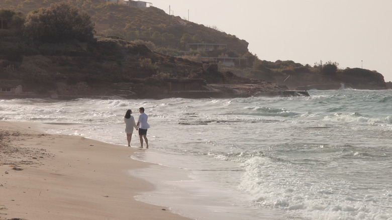 Sofia Carson's Anna De La Vega walks along a shoreline with Corey Mylchreest's Jamie Davenport in My Oxford Year