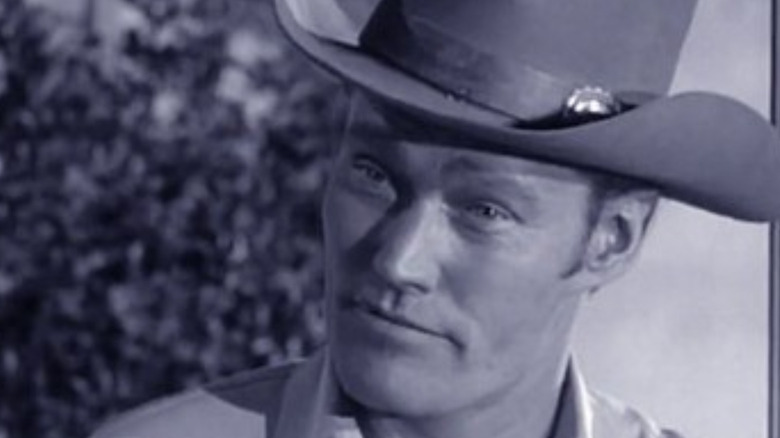 Lucas McCain (Chuck Connors) reacts with surprise to his son in The Rifleman