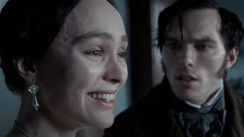 Lily-Rose Depp's Ellen Hutter with a bizarre expression on her face as Nicholas Hoult's Thomas Hutter looks at her, confused, in Nosferatu
