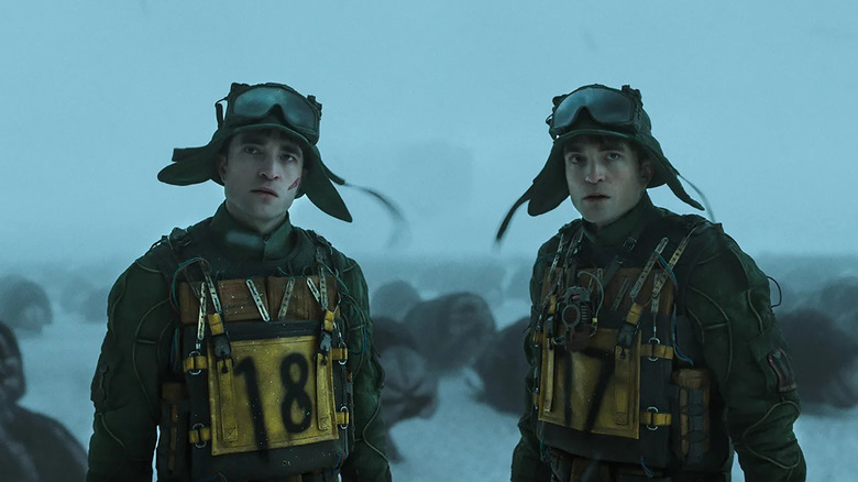 Robert Pattinson as Mickey 18 and Mickey 17 in the snow