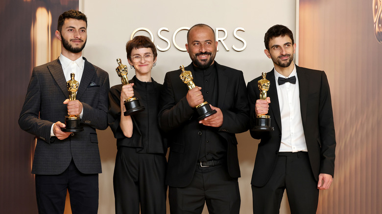 Basel Adra, Rachel Szor, Hamdan Ballal and Yuval Abraham hold their Oscars for No Other Land at the 2025 Academy Awards