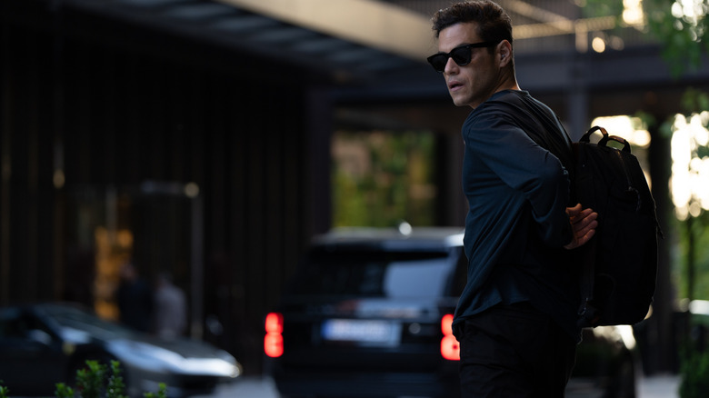 Rami Malek as CIA operative Charlie Heller wearing sunglasses in The Amateur