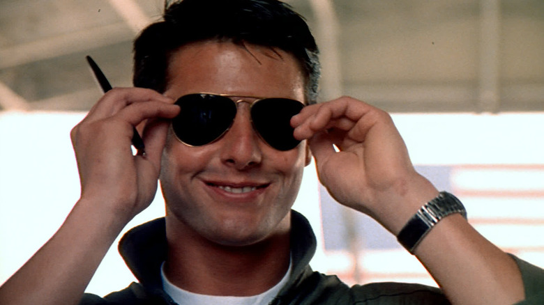 Tom Cruise smiling in sunglasses as Maverick in Top Gun