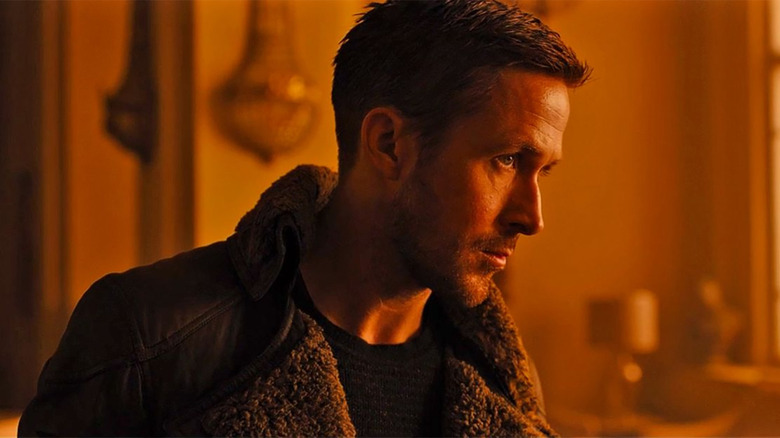 Ryan Gosling as K in a room bathed in orange light in Blade Runner 2049