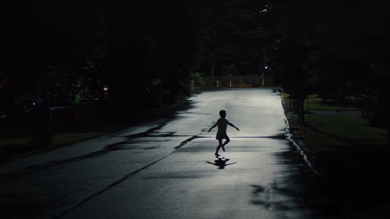 A child runs through a dark street in Weapons