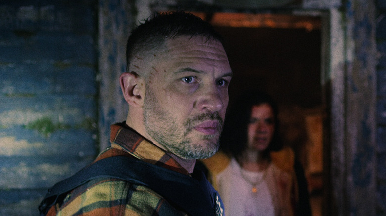 Tom Hardy's Walker looks serious while wearing a bulletproof vest in Havoc