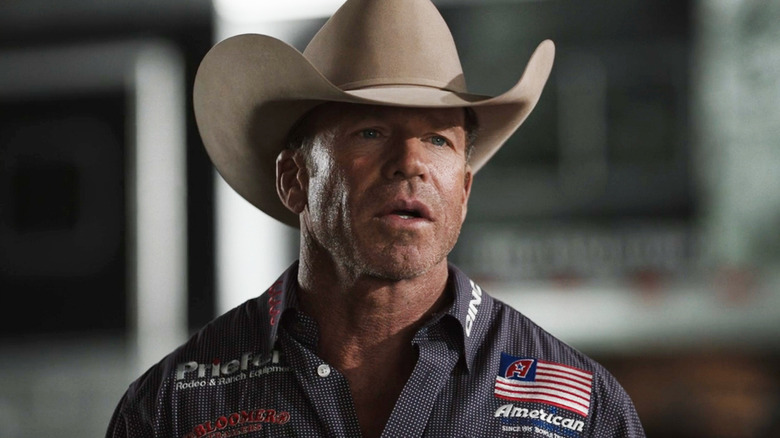 Taylor Sheridan's Travis Wheatley stands outside in a cowboy hat in Yellowstone
