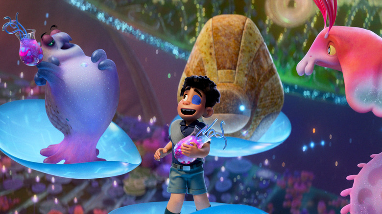 Elio stands among the ambassadors of the Communiverse, each on a curved, circuitry disc floating in the air