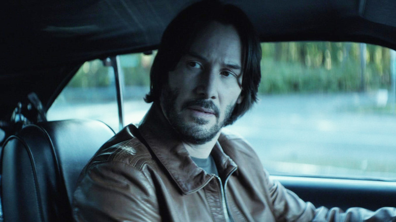 Keanu Reeves' John Wick sits in his car in John Wick