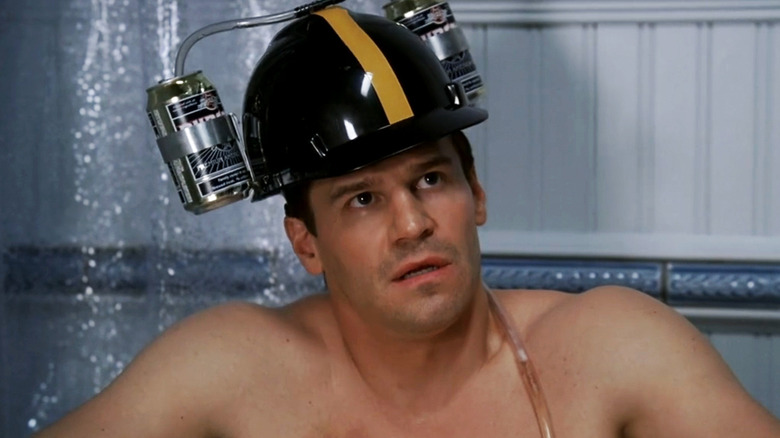 David Boreanaz's Seeley Booth sits in a bathtub wearing a helmet in Bones