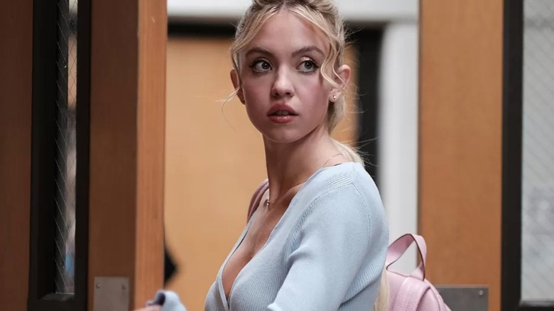 Sydney Sweeney as Cassie in Euphoria, standing in a doorway looking at something off camera