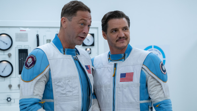 Ebon Moss-Bachrach as Ben Grimm stood next to Pedro Pascal as Reed Richards in spacesuits