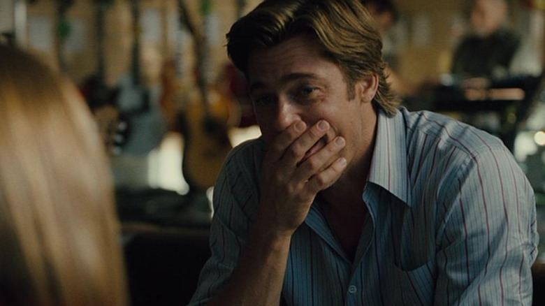 Billy Beane (Brad Pitt) looks delightfully proud of his daughter in Moneyball