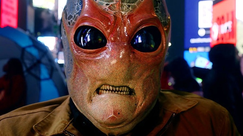An alien showing his teeth in Resident Alien