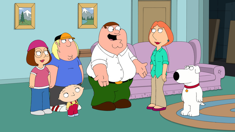 The Griffin Family standing together in their living room in 