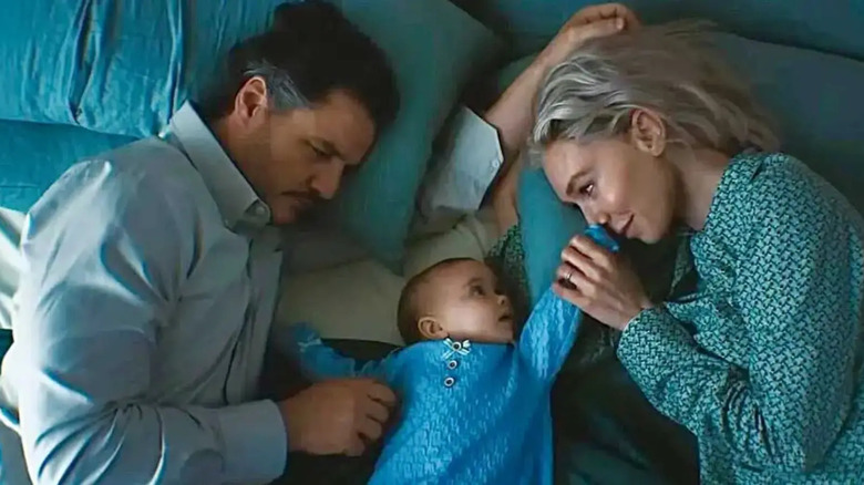 Reed and Sue on either side of their baby in bed in The Fantastic Four: First Steps