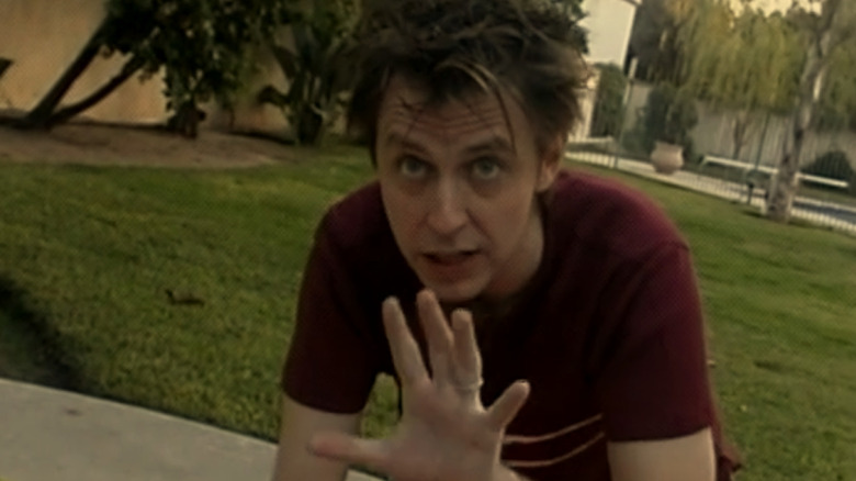 James Gunn as James holding his hand up to the camera in Lollilove