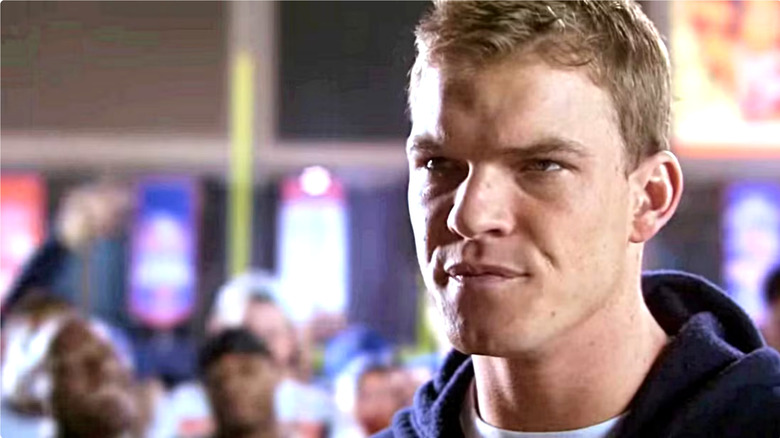 Thad staring someone down while his football team watches in the background