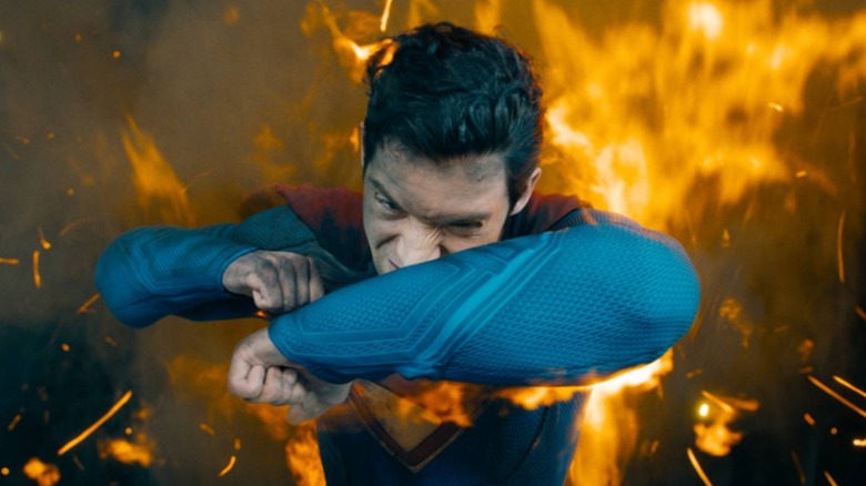 Superman (David Corenswet) shielding himself from flames in Superman (2025)