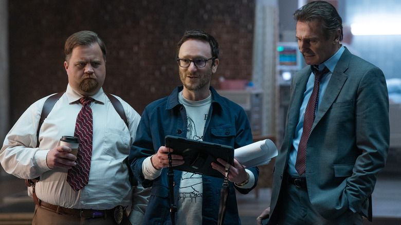 The Naked Gun director Akiva Shaffer on set with Paul Walter Hauser and Liam Neeson