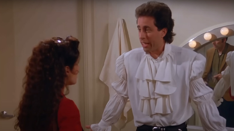 Jerry wearing a puffy shirt and talking to Elaine on Seinfeld