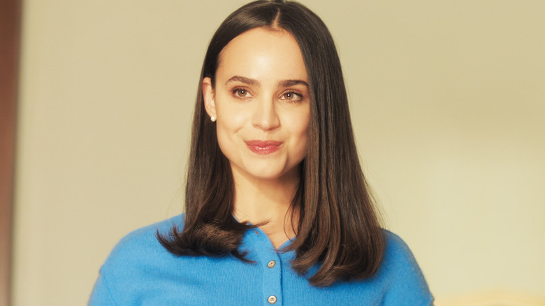 Sofia Carson's Anna De La Vega smiles against a plain background in My Oxford Year