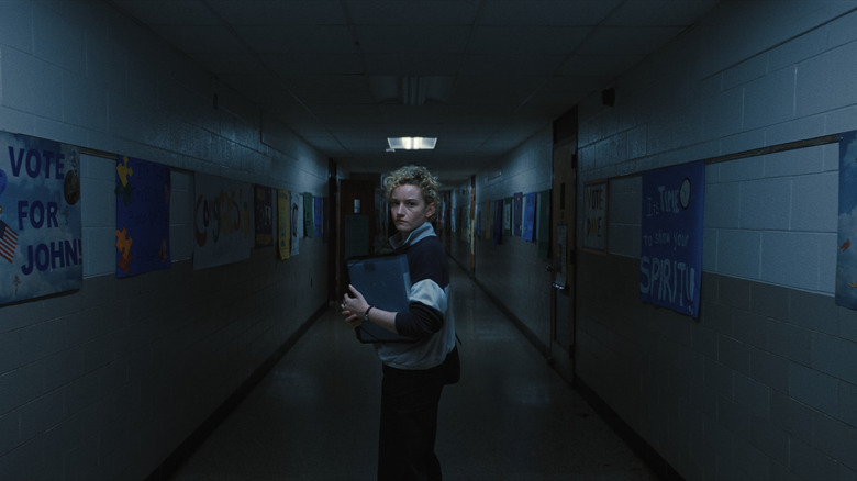 Justine Gandy stands in the dark hallway of her school in Weapons