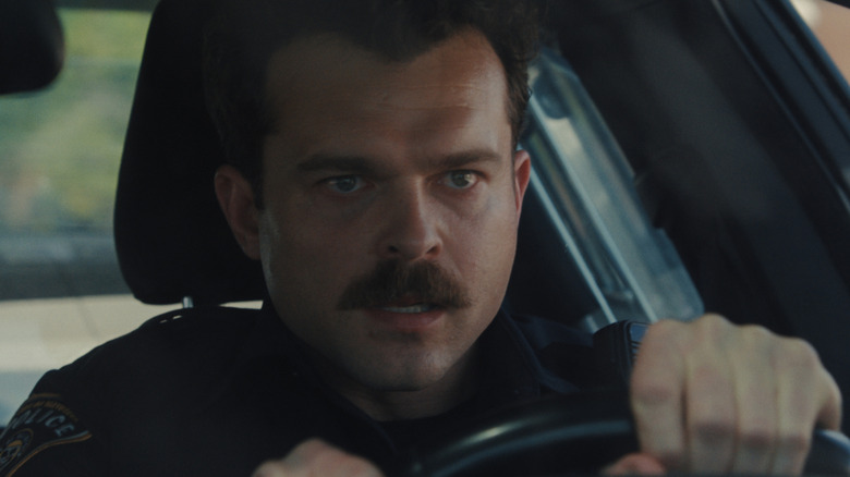 Paul drives his cop car in Weapons