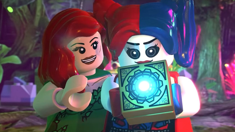Poison Ivy and Harley Quinn holding a Mother Box in Lego DC Super-Villains
