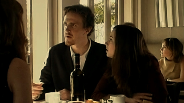 Jason Segel as Jason and Linda Cardellini as Linda sitting at dinner and looking shocked in Lollilove
