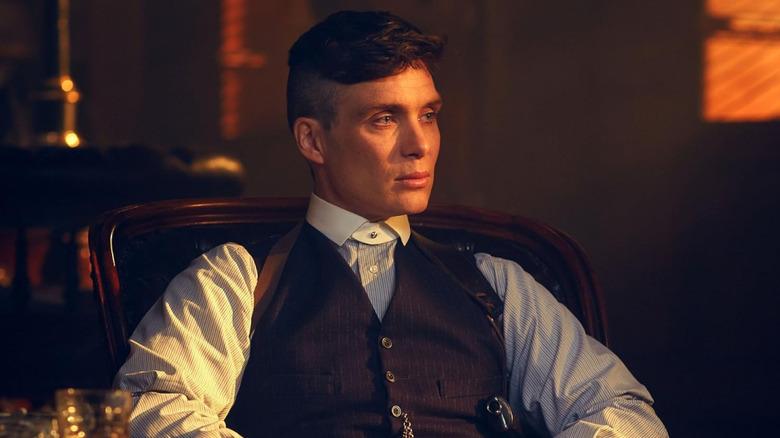 Tommy Shelby (Cillian Murphy) sitting in a chair looking pensive in Peaky Blinders