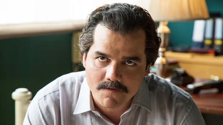 Pablo Escobar (Wagner Moura) looks up glaring in Narcos