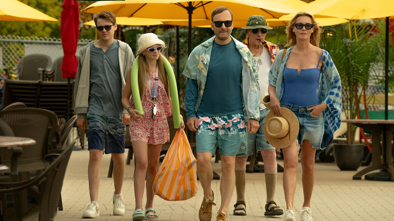 Hutch and his family walking through a old fashioned carnival resort in Nobody 2