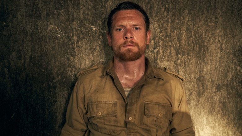 Jack O'Connell with his back against a wall