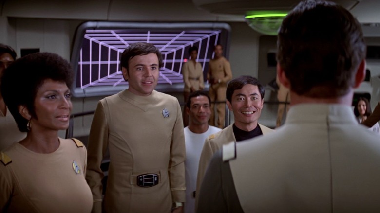 Uhura, Chekov, and Sulu greeting Admiral Kirk onto the bridge of the Enterprise