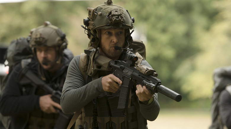 Wozniak (Eric Ladin) pursues with a gun in Six.