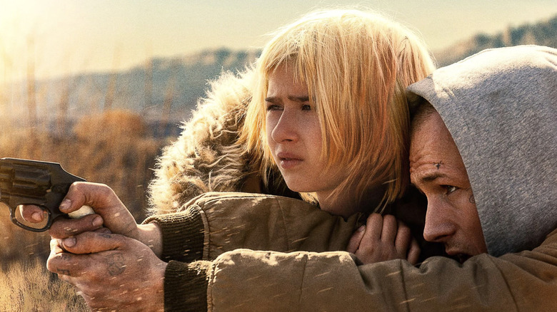 She Rides Shotgun - Nate (Taron Egerton) aiming gun as Polly (Ana Sophia Heger) huddles near him