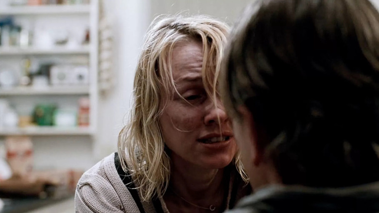 Anna crying and haggard, staring at George in Funny Games