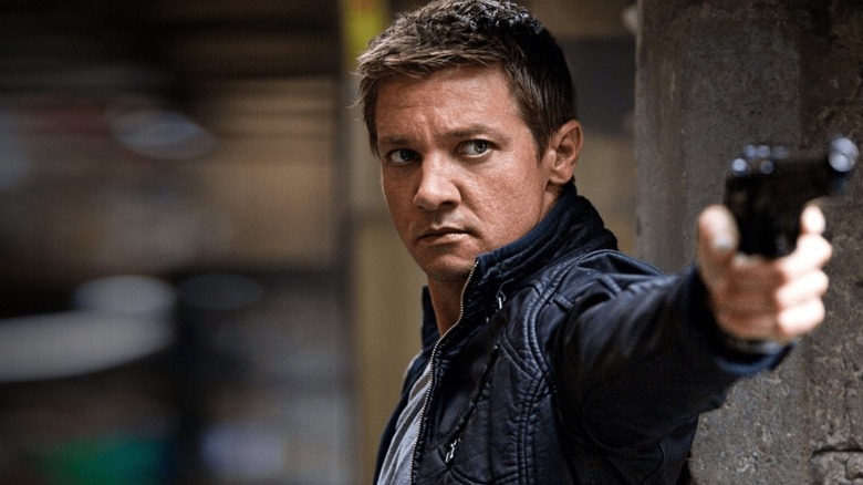Jeremy Renner pointing a gun
