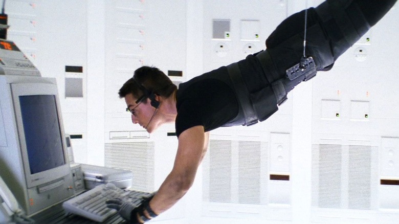 Tom Cruise as Ethan Hunt hanging from the ceiling in the CIA clean room in Mission: Impossible
